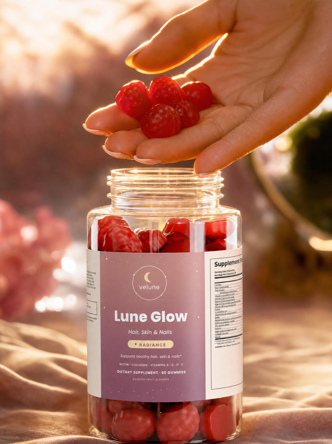 Lune Glow gummies held above the jar