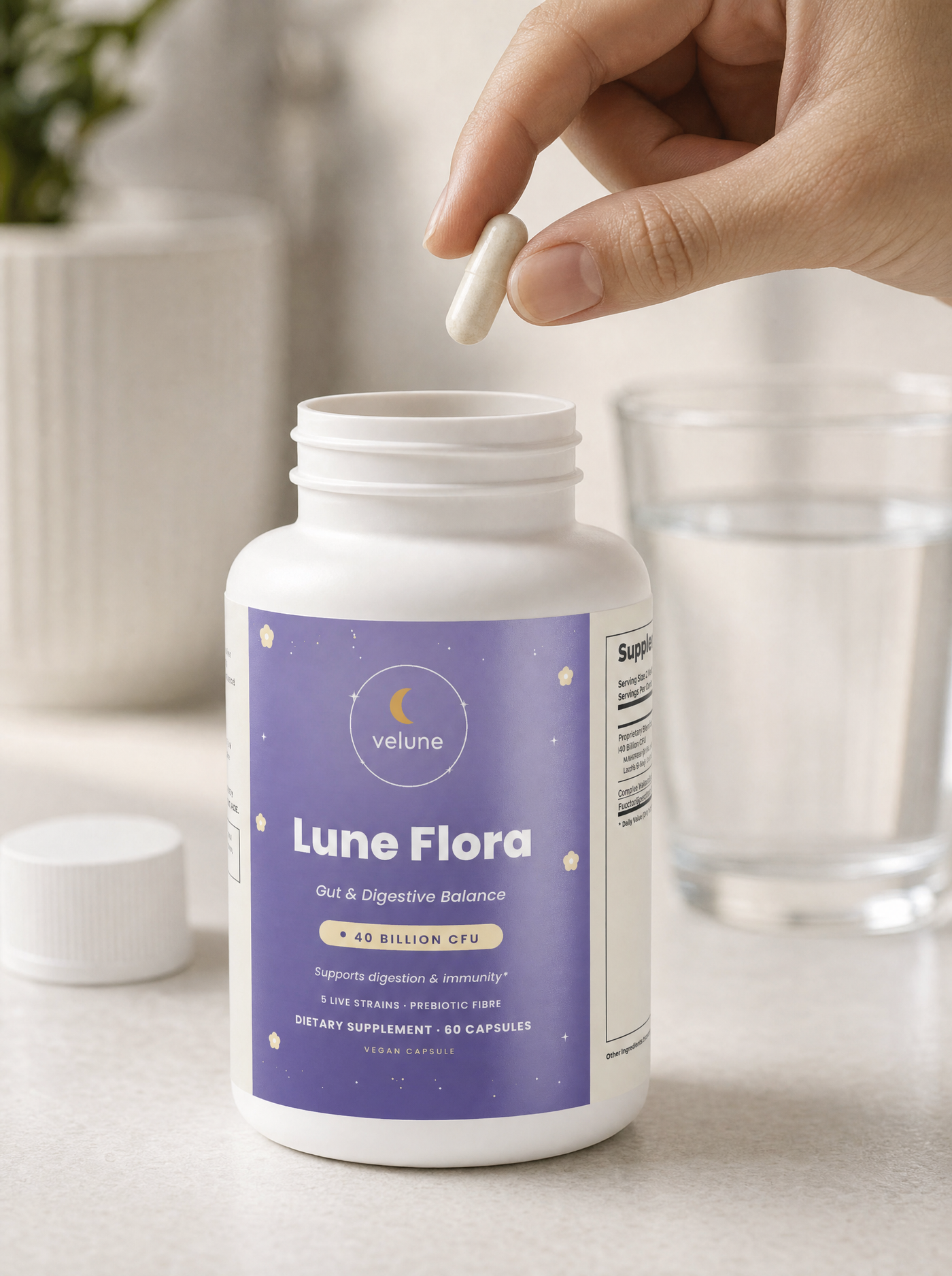Lune Flora capsule held above the bottle