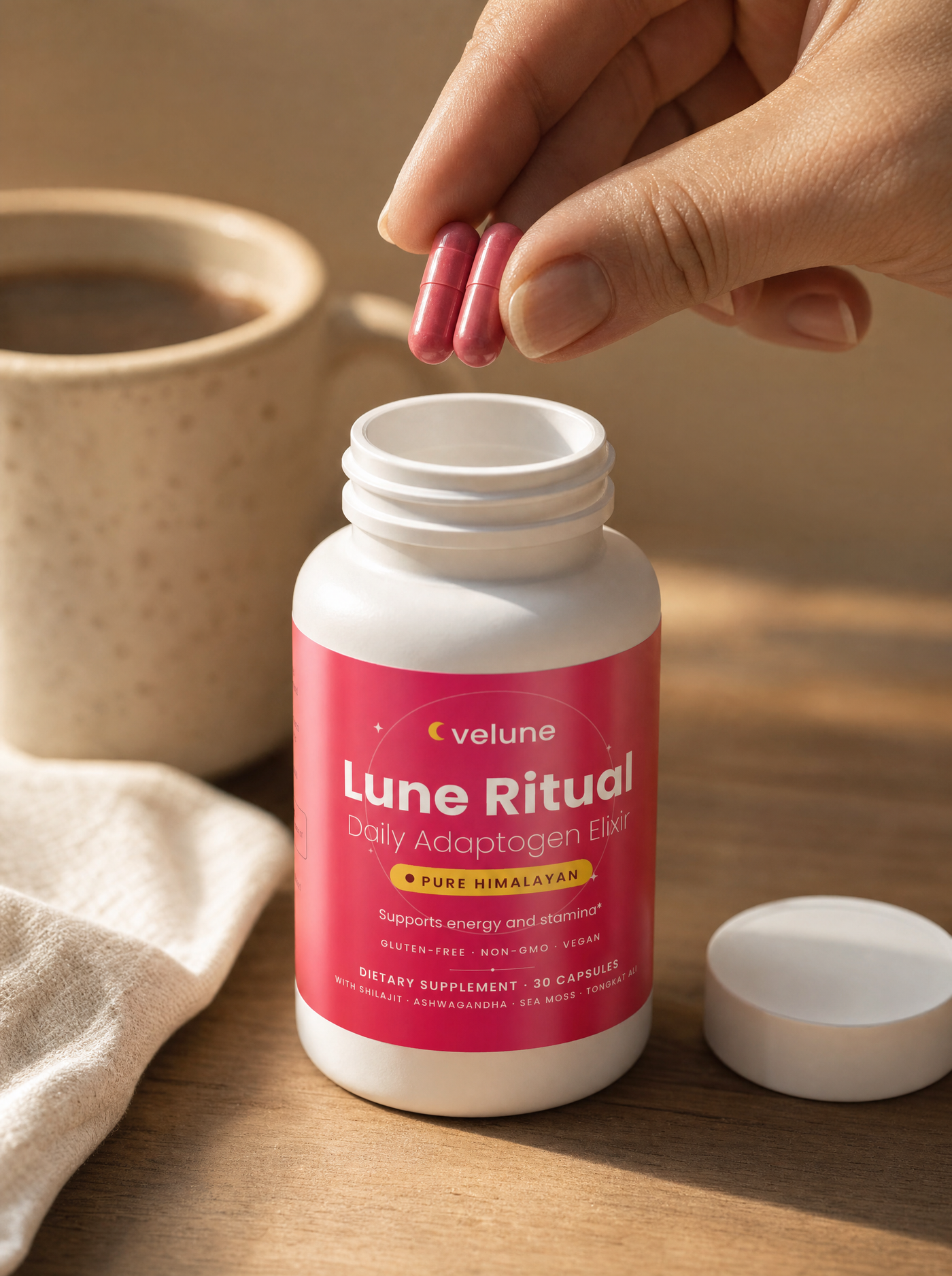 Lune Ritual capsules held above the bottle